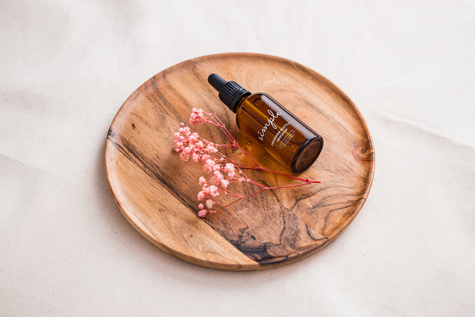 Amber dropper bottle on wooden tray mockup