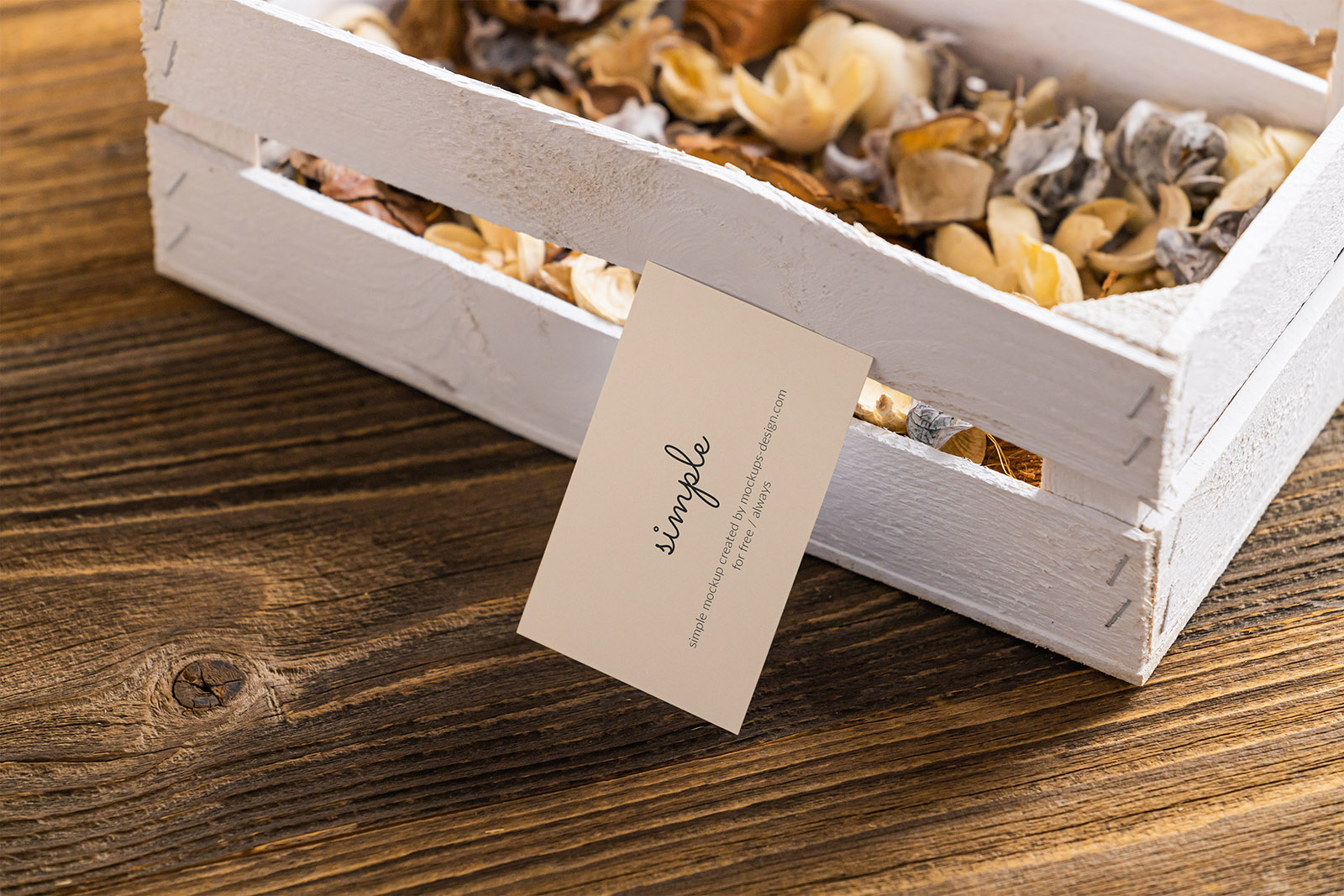 Business card next to wooden crate mockup