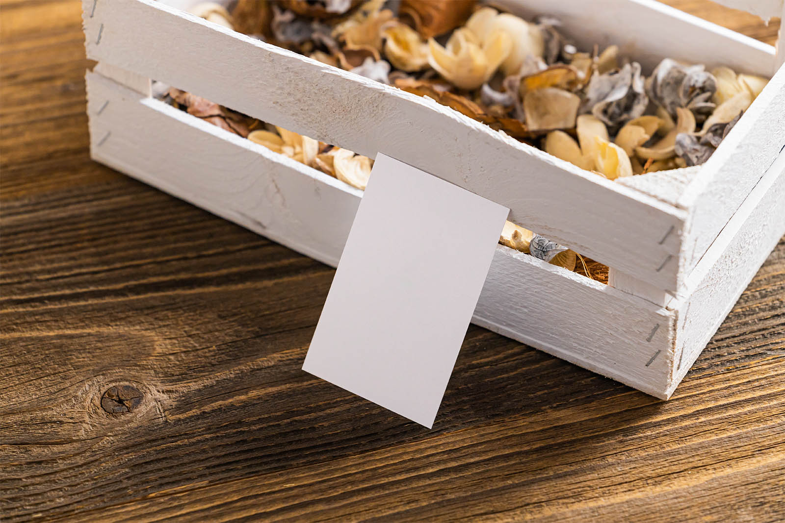 Business card next to wooden crate mockup