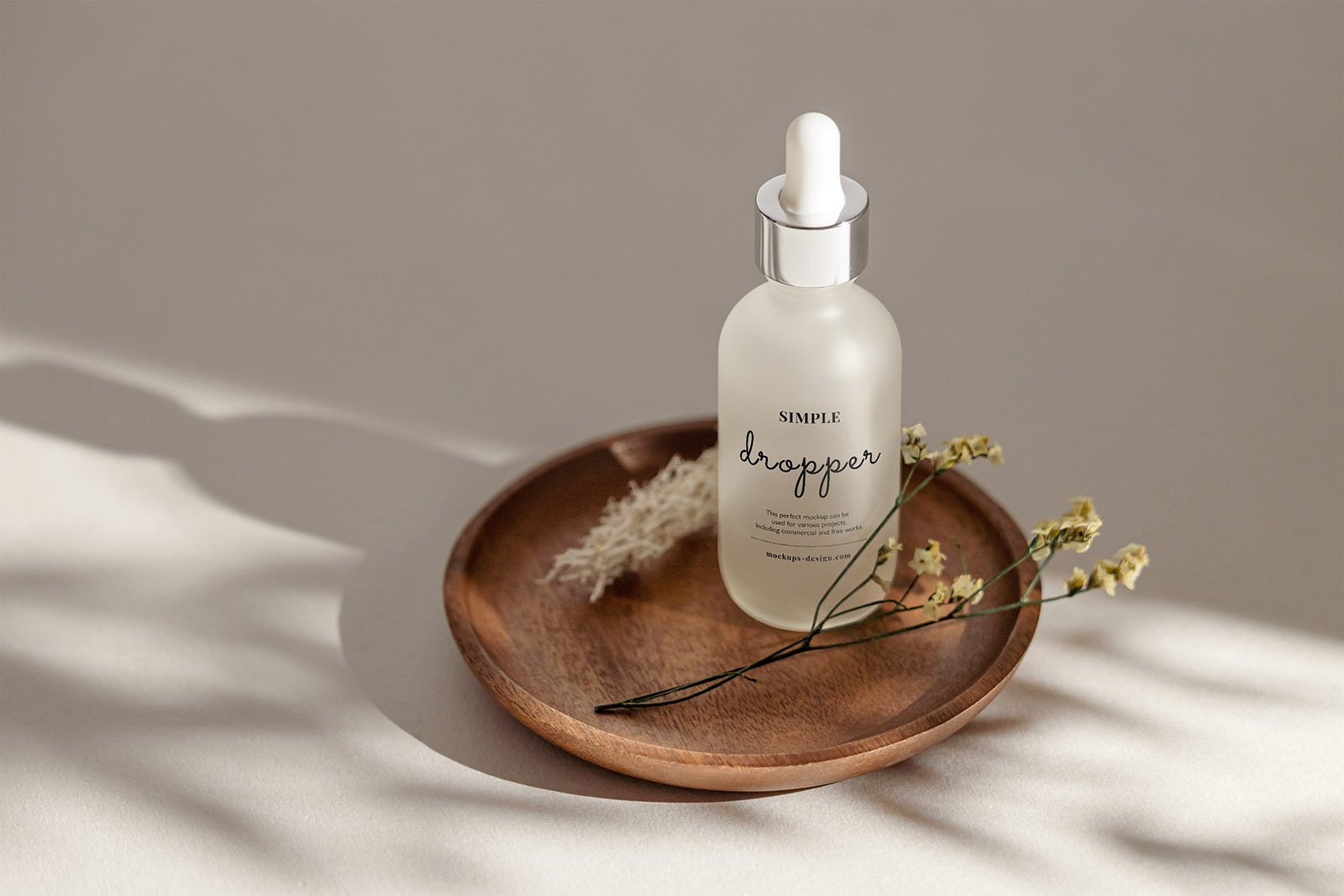 Frosted dropper bottle on wooden tray mockup