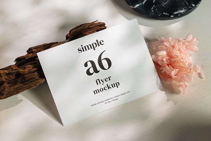 A6 flyer on white planks mockup
