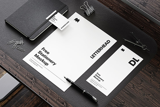 Stationery on the wooden desk mockup