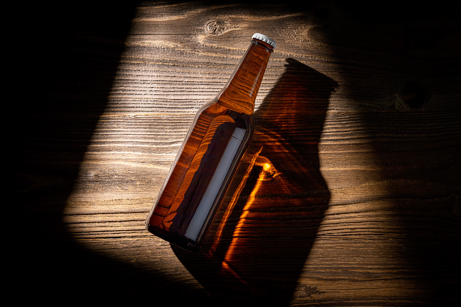 Beer bottle on wooden background mockup
