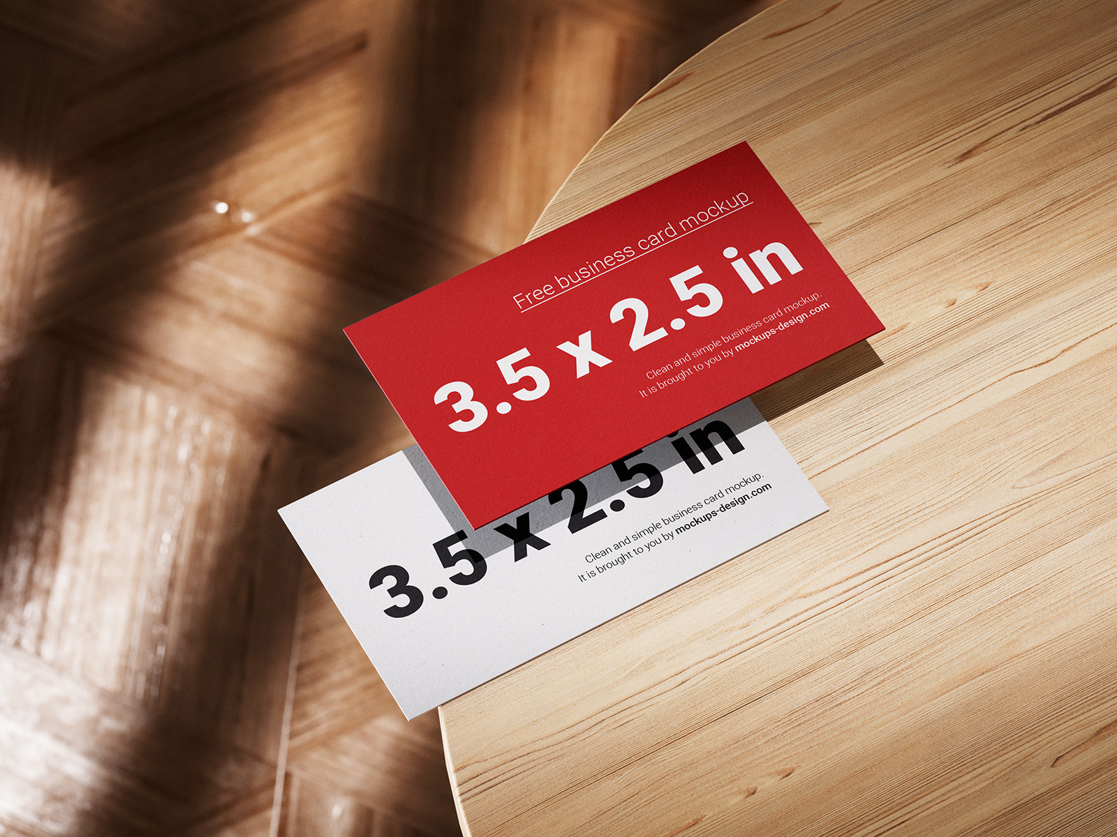 Business cards lying on a wooden table mockup